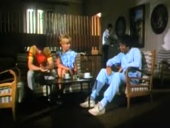 A retro blonde in underwear licks a man's prick while making out with him.